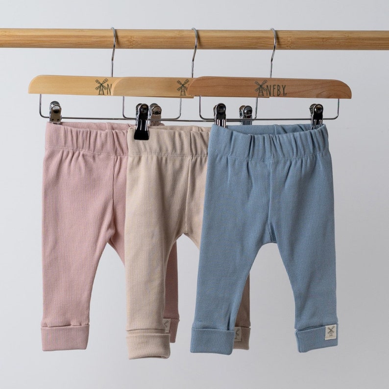 rolled hem leggings in various colours hanging from Aneby clothes hangers