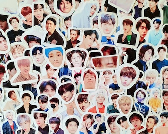 May include: A collection of colorful stickers featuring various images of men's faces. The stickers are printed on white paper and have a glossy finish.