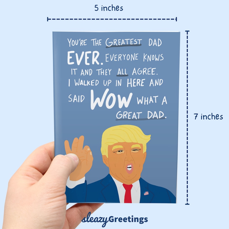 Puede incluir: Una tarjeta de felicitaci&oacute;n, de aproximadamente 12,7 cm de ancho y 17,8 cm de alto, con un fondo azul y el texto "You're the Greatest Dad Ever". La tarjeta presenta una ilustraci&oacute;n de dibujos animados de un hombre con traje y corbata.