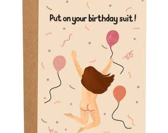 May include: A birthday card with a woman jumping in the air with balloons and confetti. The card says "Put on your birthday suit!"