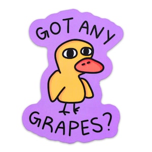 May include: A die-cut sticker featuring a yellow cartoon duck with a red beak and black eyes. The duck is set against a purple background and the text "GOT ANY GRAPES?" is written above and below the duck.