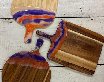 Serving boards made from resin embellished cutting boards. Large size, these are designed with Clemson colors.