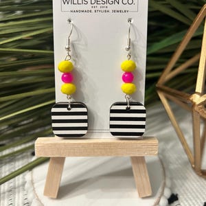 black and white stripe wooden earring with pink and yellow beaded accent