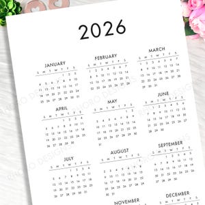 May include: A white 2026 yearly calendar page featuring black text and numbers organized into twelve monthly grids. The layout displays months from January through December, each with columns for days of the week, presented in a clean, simple format.