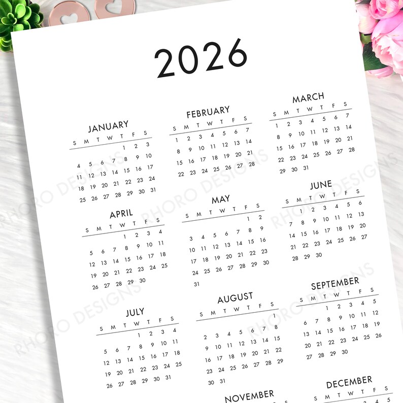 May include: A white 2026 yearly calendar page featuring black text and numbers organized into twelve monthly grids. The layout displays months from January through December, each with columns for days of the week, presented in a clean, simple format.