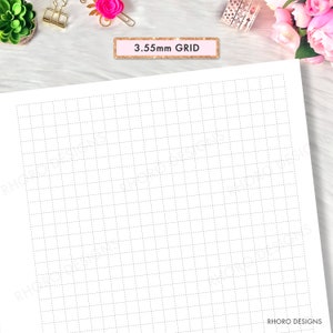 May include: A white sheet of paper with a 3.55mm grid pattern. The grid lines are light gray and dotted. The text "3.55mm GRID" is printed in a pink box at the top of the page.
