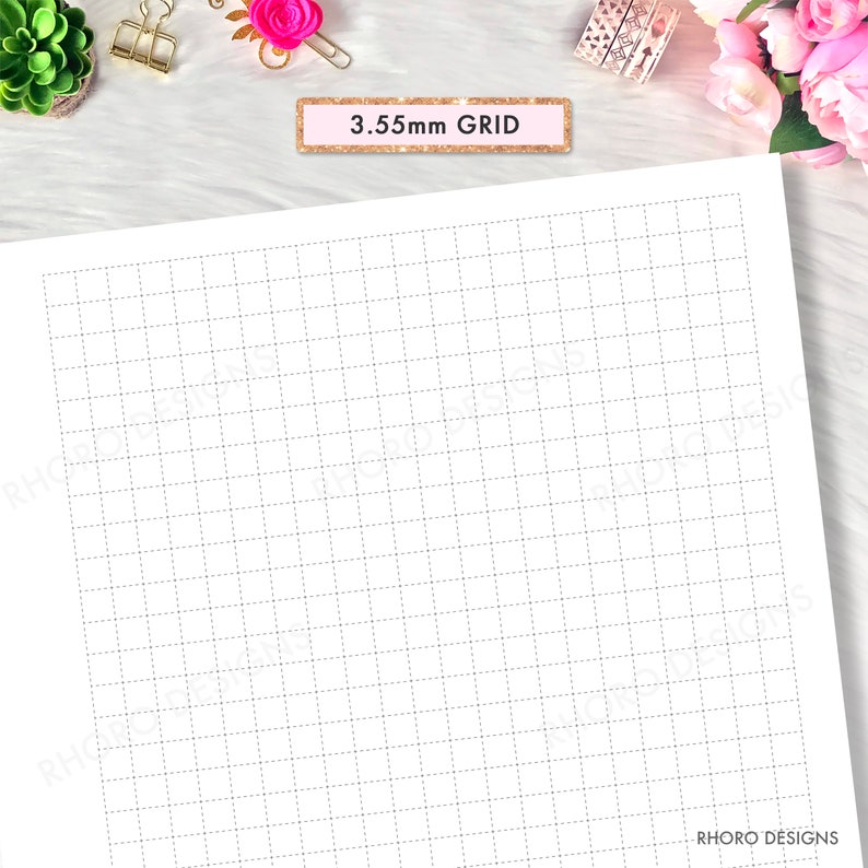 May include: A white sheet of paper with a 3.55mm grid pattern. The grid lines are light gray and dotted. The text "3.55mm GRID" is printed in a pink box at the top of the page.