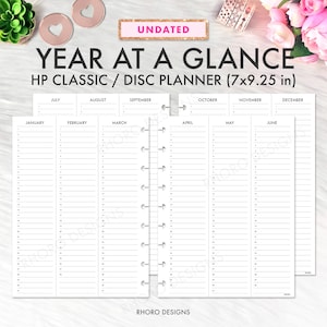 May include: Undated HP Classic/Disc Planner with a "Year at a Glance" layout. The planner measures 7x9.25 inches and features monthly sections from January to December. The design includes a white background with black text and a disc-bound binding.