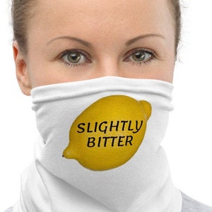 May include: White face mask with a yellow lemon graphic and the text "SLIGHTLY BITTER" printed on it.