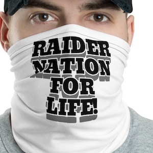 Könnte beinhalten: Weiße Gesichtsmaske mit schwarzem Text, der "Raider Nation For Life!" lautet.
