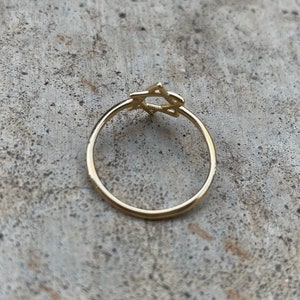 May include: A gold ring with a Star of David design.