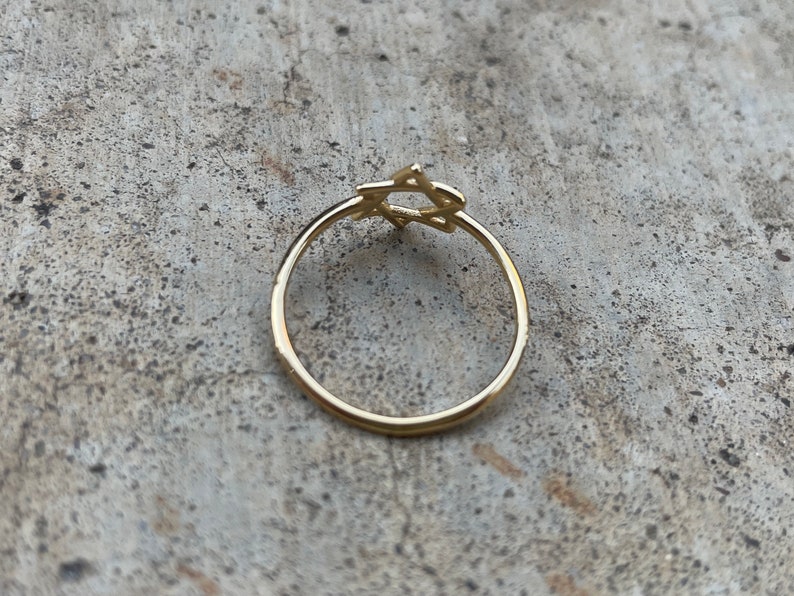 May include: A gold ring with a Star of David design.