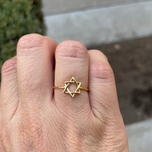 May include: A gold ring with a Star of David design.