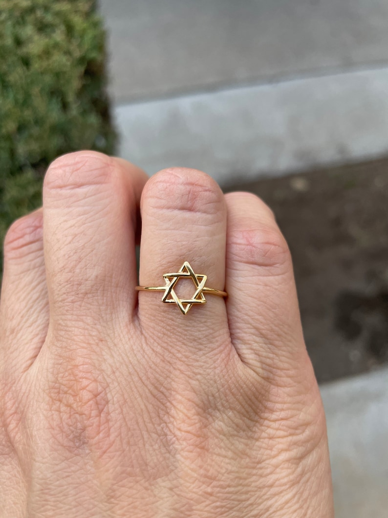 May include: A gold ring with a Star of David design.