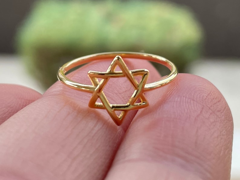 May include: A gold ring with a Star of David design.