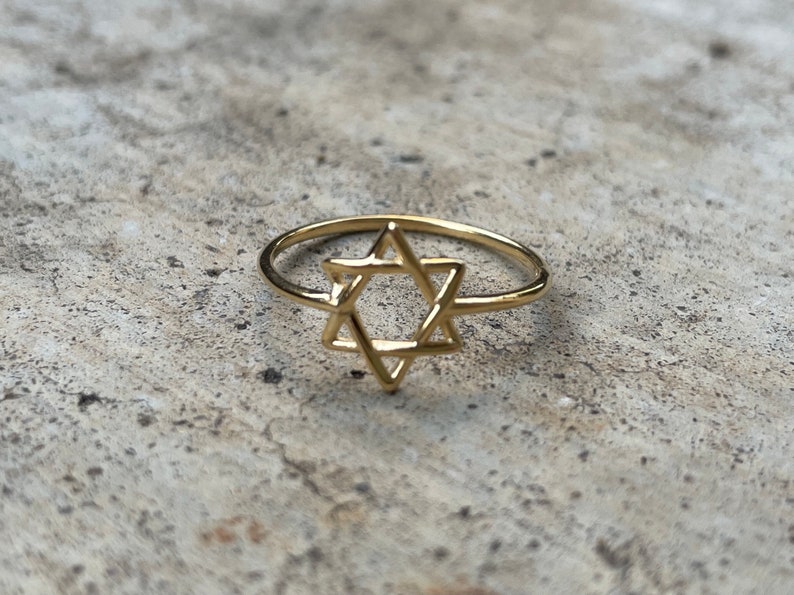 May include: A gold ring with a Star of David design.