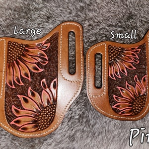 Puede incluir: Dos fundas de cuero con dise&ntilde;os de girasoles, una etiquetada como "Large" y la otra como "Small". Ambas fundas son marrones con detalles de girasoles rosas. El texto "Pink" es visible en la parte inferior de la imagen.