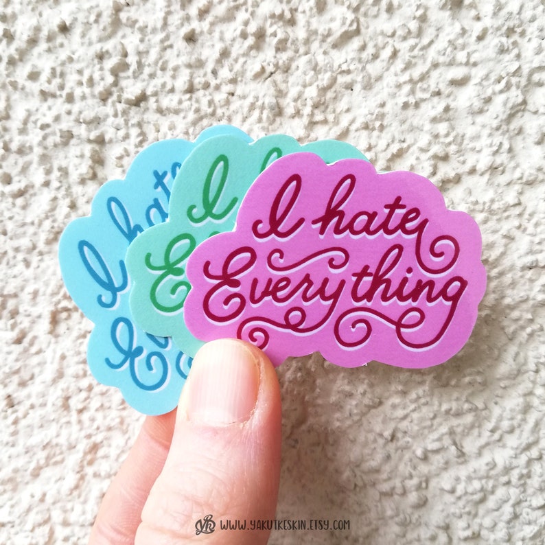 May include: Three cloud-shaped stickers with the text "I hate everything" in a cursive font. The stickers are in pink, green, and blue.