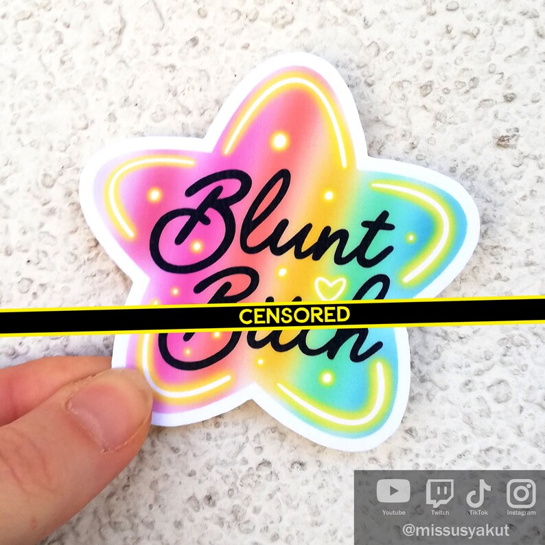 May include: A rainbow star-shaped sticker with the text "Blunt [CENSORED]" in black cursive lettering. The sticker has a neon outline.