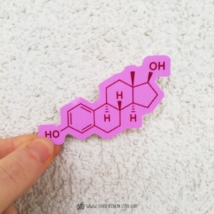 May include: Pink vinyl sticker featuring a chemical structure diagram of a molecule with the text "OH" and "HO" in red.