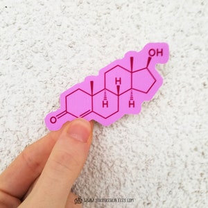 May include: A pink sticker featuring a molecular structure diagram. The sticker is in the shape of a molecule and has the letters "OH" at the top. The website address "www.yakutikeskin.etsy.com" is at the bottom.