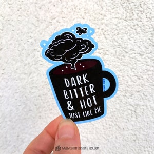 May include: Black and white sticker of a coffee mug with steam coming out of it. The mug says "Dark Bitter & Hot Just Like Me".