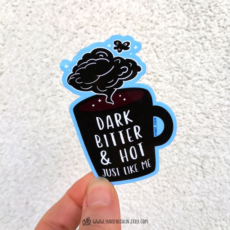 May include: Black and white sticker of a coffee mug with steam coming out of it. The mug says "Dark Bitter & Hot Just Like Me".