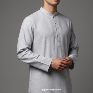 May include: A light gray long-sleeved tunic with a mandarin collar and buttoned placket. The tunic has a textured appearance and is made of a soft fabric. The sleeves have buttoned cuffs. The bottom right corner of the image has the text "@gcouturepattern".