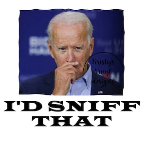 May include: A white t-shirt with a black and white image of a man with the text "I'D SNIFF THAT" printed on it.