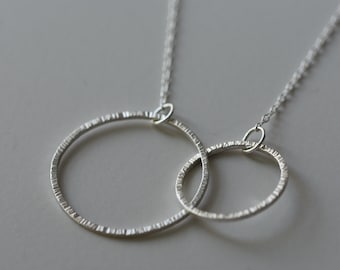 Entwined Silver Circle Necklace with a Line Texture