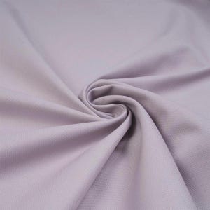 May include: A solid light lavender fabric with a smooth, matte texture. The material is gathered in the centre, creating soft, radiating folds and drapes that highlight the consistent, uniform colour and fine weave of the textile surface.