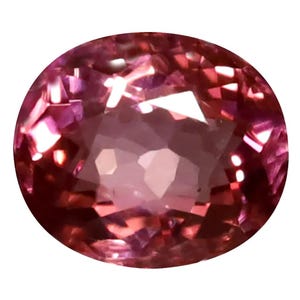 May include: A faceted, oval-cut gemstone with a blend of pink and purple hues. The gem's surface reflects light, creating a sparkling effect. The gemstone is set against a white background.