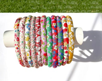 May include: A set of 10 colorful fabric headbands with floral and fruit patterns. The headbands are made of a soft, stretchy material and are perfect for adding a touch of style to any outfit.