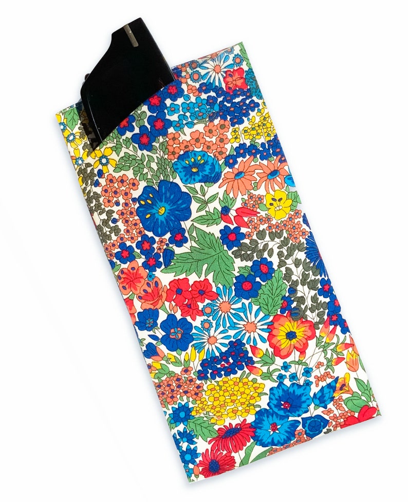 May include: A white fabric glasses case with a floral pattern in shades of red, blue, yellow, and green. The case has a black glasses cleaning cloth inside.