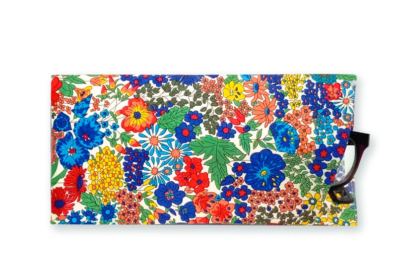 May include: A floral patterned glasses case with a white background and a variety of colorful flowers, including red, blue, yellow, and orange. A pair of glasses is partially visible in the case.
