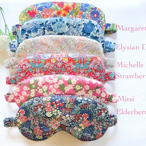 May include: A stack of six colorful floral eye masks with different patterns. The eye masks are labeled with names: Margaret, Elysian Day, Michelle Strawberry, Mitsi Elderberry.