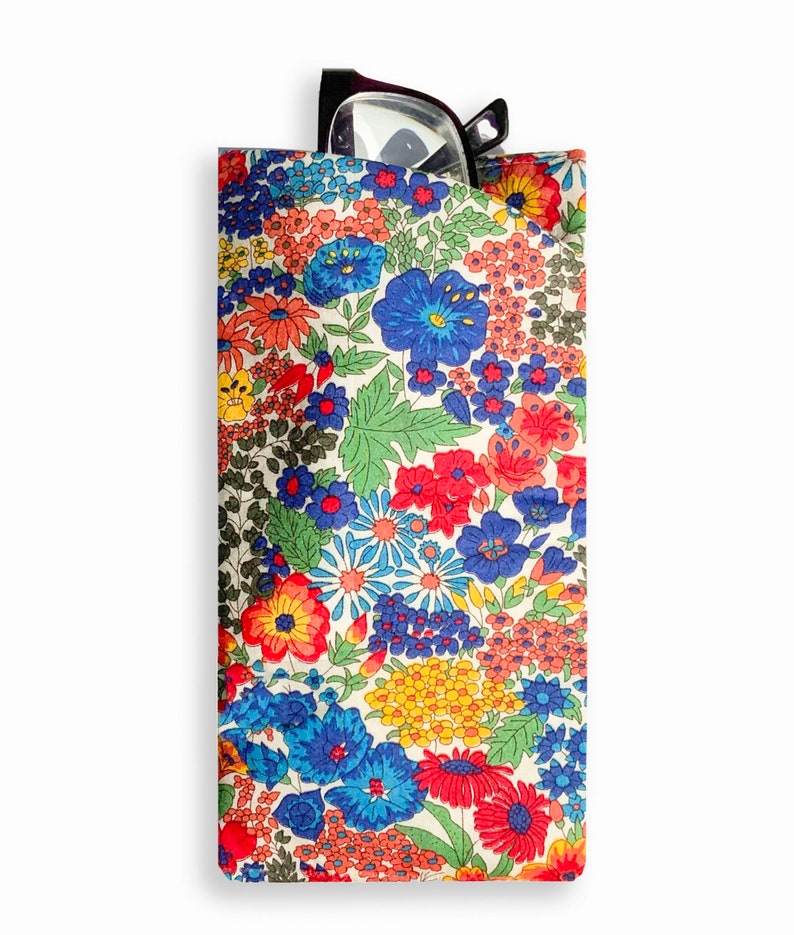 May include: A floral patterned glasses case with a pair of black glasses inside. The case is made of fabric and has a white background with red, blue, yellow, and green flowers.