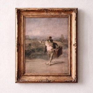 May include: A framed oil painting depicting a green frog wearing a top hat and carrying a brown suitcase whilst walking along a path. The artwork is encased in an ornate, weathered gold-toned wooden frame with intricate carved detailing.