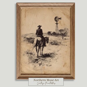 Peut inclure: Une estampe vintage encadrée en noir et blanc représentant un cowboy à cheval. L'œuvre d'art montre une scène rurale avec un moulin à vent et un petit bâtiment. L'impression a une teinte sépia et le texte "Northern Muse Art Vintage Printables".