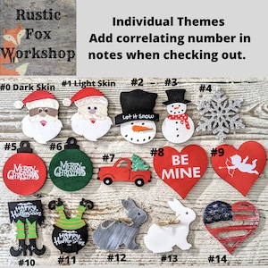 Pu&ograve; includere: Una collezione di 14 ornamenti in legno con vari temi, tra cui Natale, Halloween, San Valentino e patriottico. Gli ornamenti sono dipinti in vari colori, tra cui rosso, verde, bianco, nero e blu. Gli ornamenti sono numerati da 0 a 14. Il testo "Rustic Fox Workshop" &egrave; visibile nell'angolo in alto a sinistra dell'immagine. Il testo "Temi individuali Aggiungi il numero corrispondente nelle note al momento del checkout." &egrave; visibile nell'angolo in alto a destra dell'immagine.