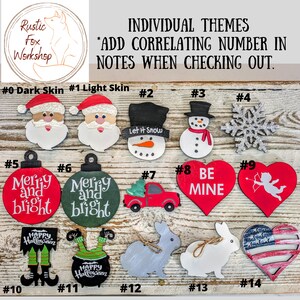 May include: A collection of wooden ornaments with various themes, including Santa Claus, snowmen, hearts, and bunnies. The ornaments are painted in bright colors and feature text like "Merry and Bright" and "Be Mine."