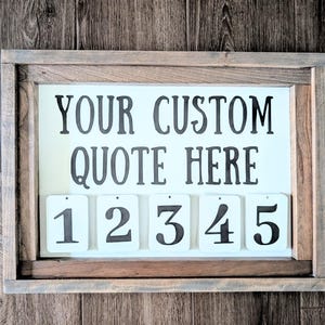 May include: A framed wooden sign with the text "YOUR CUSTOM QUOTE HERE" in black lettering. Below are five numbered tags from 1 to 5. The sign is set against a wooden background.