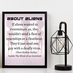 May include: A framed print with a white background and black text that reads "ABOUT ALIENS". The text continues with a quote about aliens and a deadly virus. The quote is attributed to Oliver Markus Malloy and the book "Inside The Mind of an Introvert".