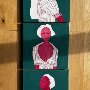 May include: Three canvases with a green background and a red figure in a white striped shirt. The figure is depicted in different poses on each canvas.
