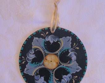 4 inch wooden ornament painted in the Gudbrandsdalen style of Rosemaling.  "Rosemaling by Jan"