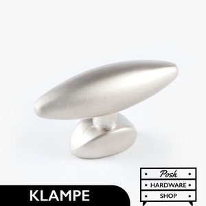 May include: A silver-toned, oval-shaped cabinet knob with a slightly raised, rounded base. The knob has a smooth, brushed finish.