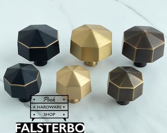 May include: Six hexagonal cabinet knobs in matte black, brushed gold, and antique bronze finishes. Each knob features a faceted top surface. A logo graphic with the text Posh HARDWARE SHOP and the word FALSTERBO is visible in the lower left corner.