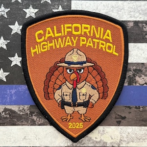 May include: Embroidered patch featuring a turkey in a California Highway Patrol uniform. The patch is shield-shaped with the text "CALIFORNIA HIGHWAY PATROL" and the year "2025". The background shows an American flag with a blue line.