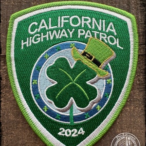 May include: Green embroidered patch with the text "CALIFORNIA HIGHWAY PATROL" and a four-leaf clover with a green leprechaun hat on top. The year 2024 is embroidered at the bottom.
