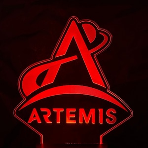 May include: Red acrylic night light with a stylized letter A and the word "ARTEMIS" in a diamond shape.